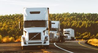 white-volvo-semi-truck-on-side-of-road-2199293